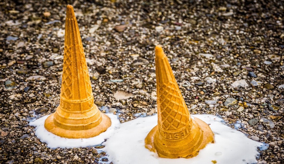 Two upside-down ice-cream cones melting on the ground