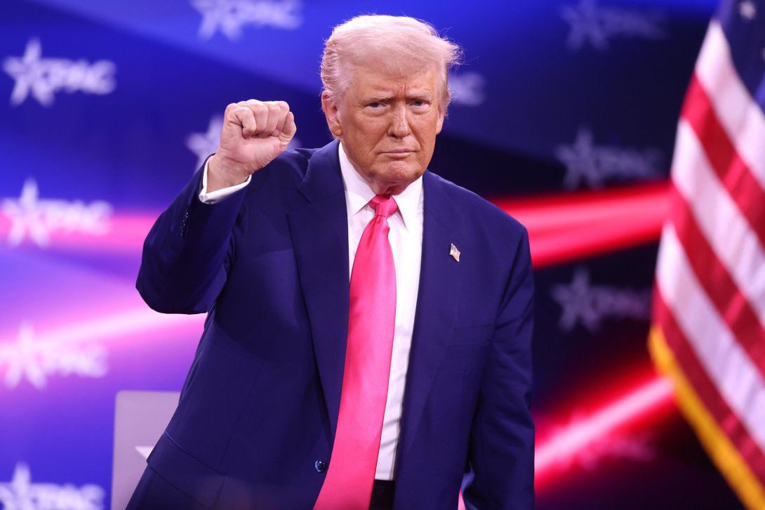 Trump holding his fist up at the 2025 CPAC Convention