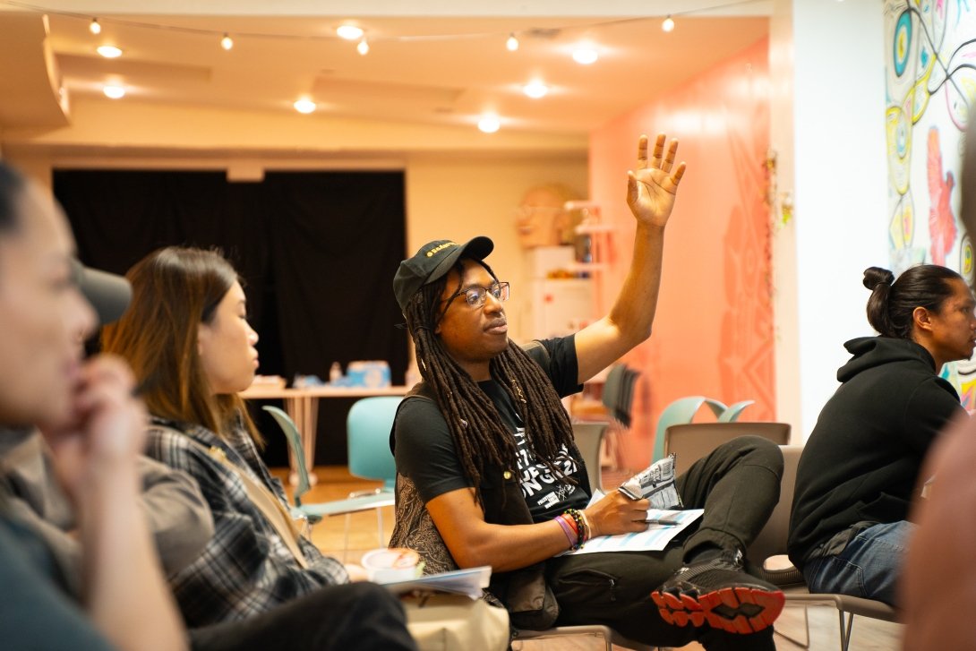 A man at Free Press' community event in Pilsen, Chicago, raises his hand