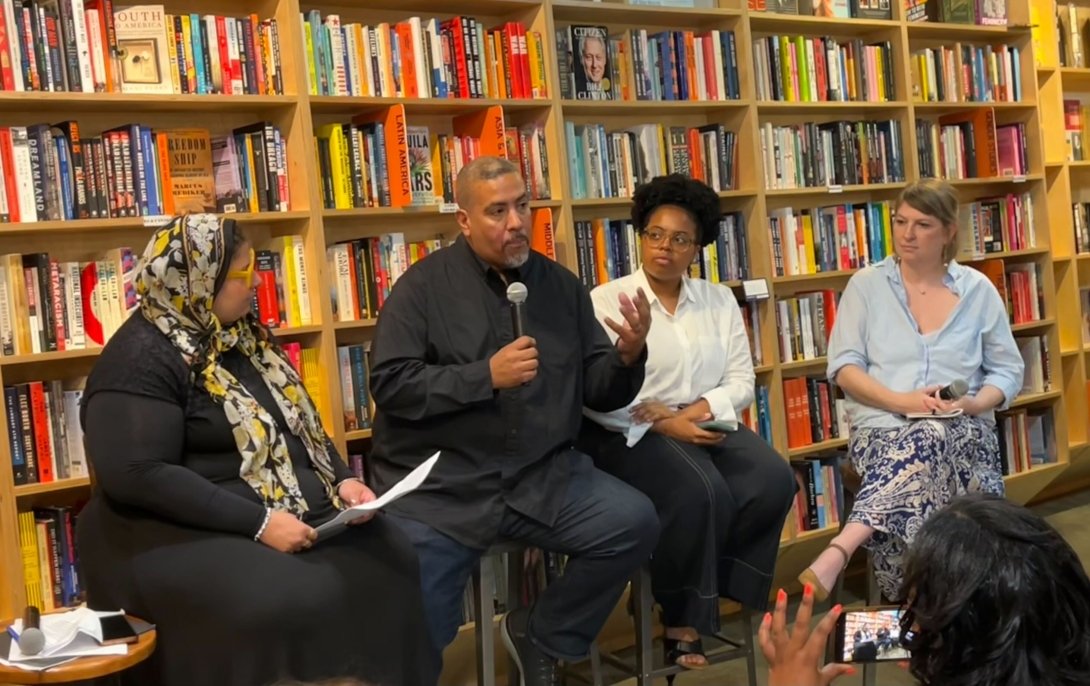 Free Press’ Joseph Torres (second from left) sitting in Solid State Books with three other people