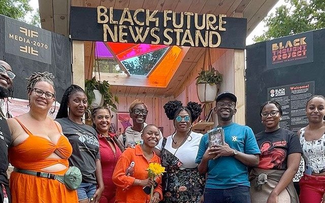 Photo of organizers and volunteers in front of The Black Future Newsstand installation