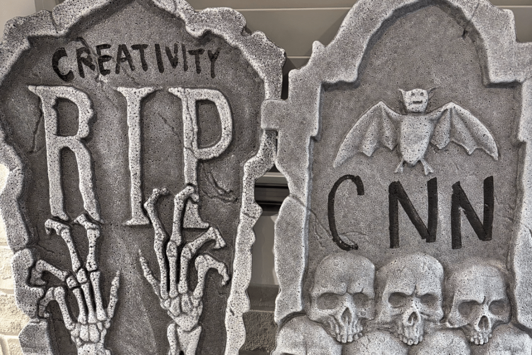 Fake tombstones reading "RIP Creativity" and "RIP CNN"
