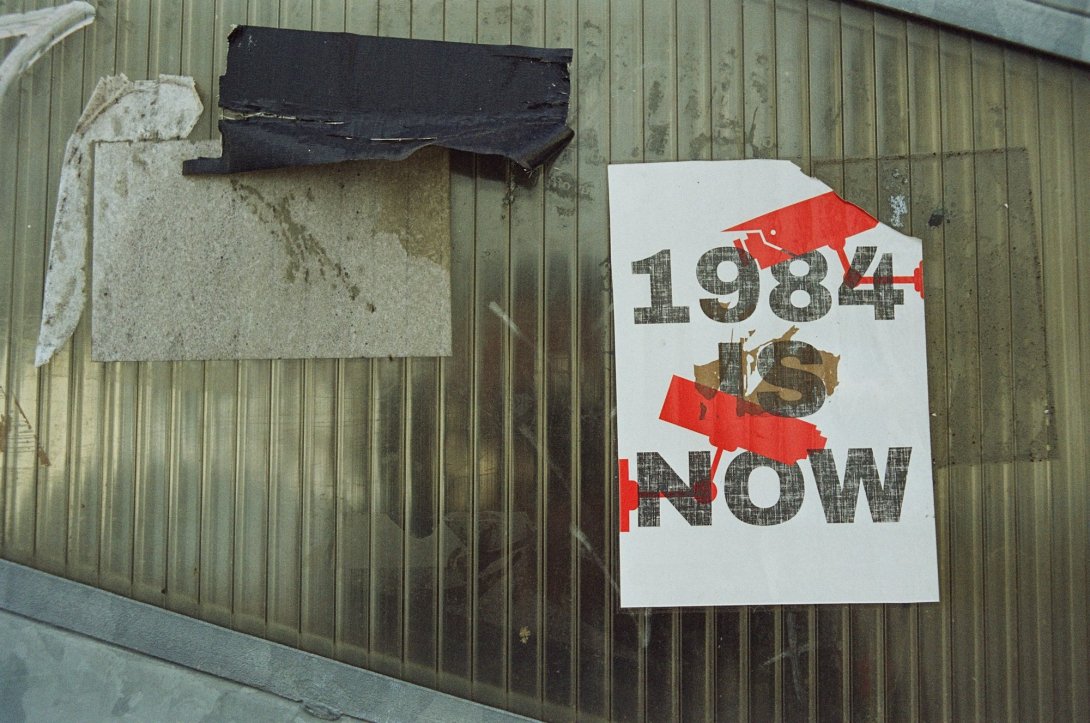 A poster reading "1984 Is Now"