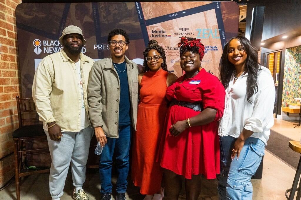 Media 2070 team members with visitors at the Black Future Newsstand exhibit in Los Angeles