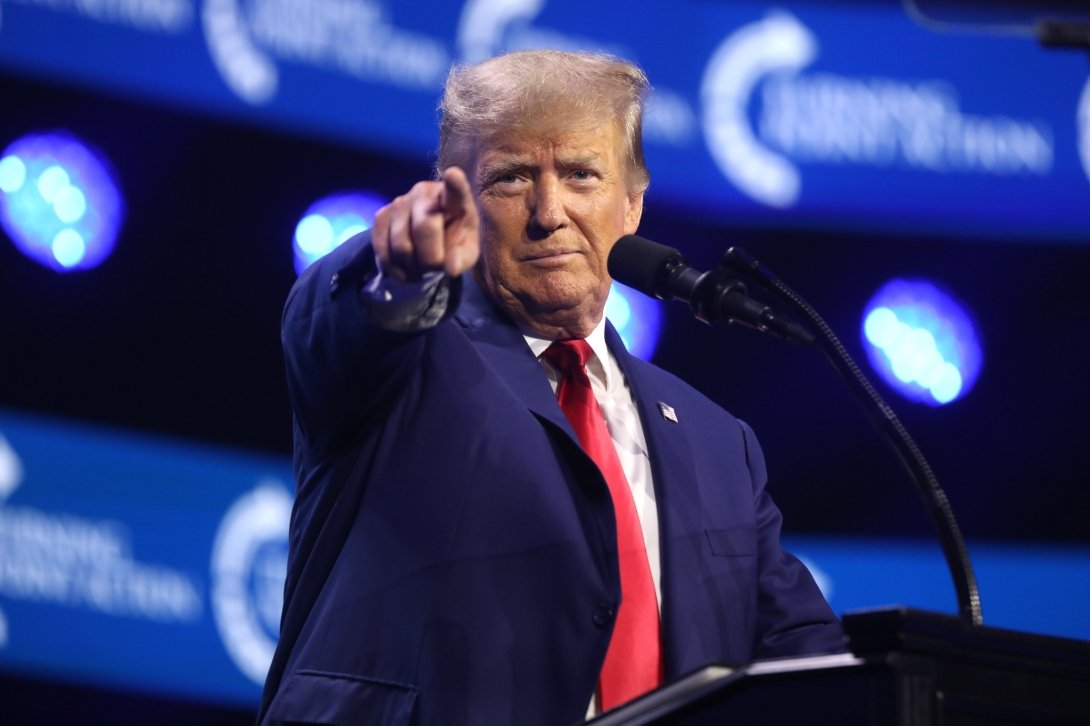 Trump pointing a finger on the stage of the 2023 Turning Point Action Conference