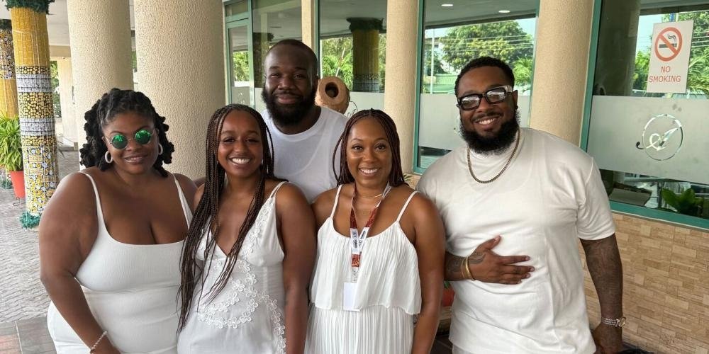 Free Press staffers Venneikia Williams and Diamond Hardiman standing with fellow participants at a reparations conference in Ghana.