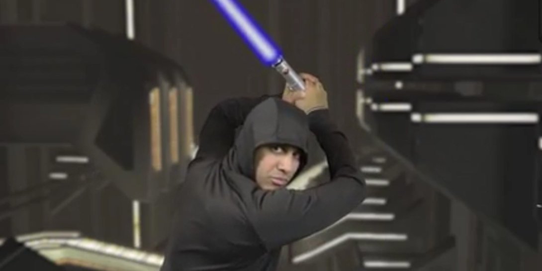 FCC Chairman Ajit Pai holding a Star Wars lightsaber