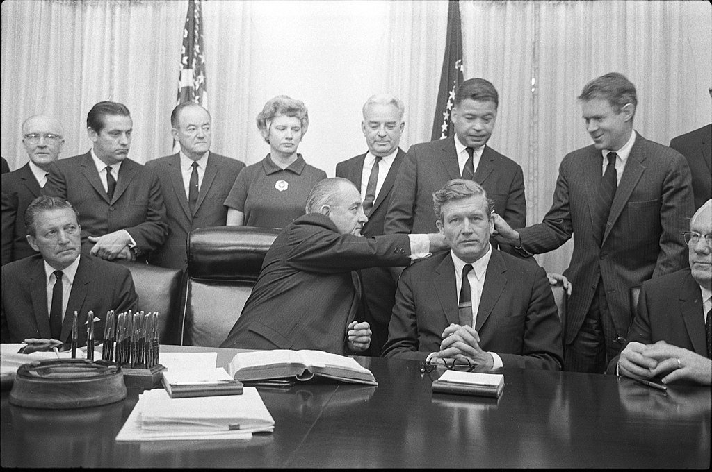 Members of Kerner Commission seated at table with President Lyndon B. Johnson