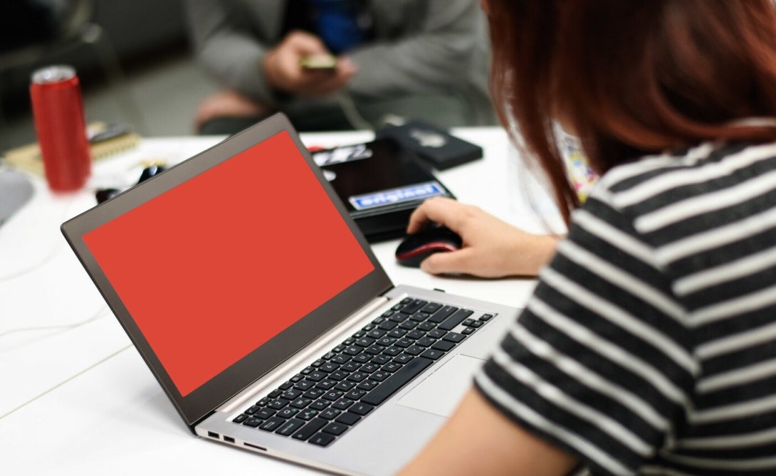 Woman using laptop with red screen