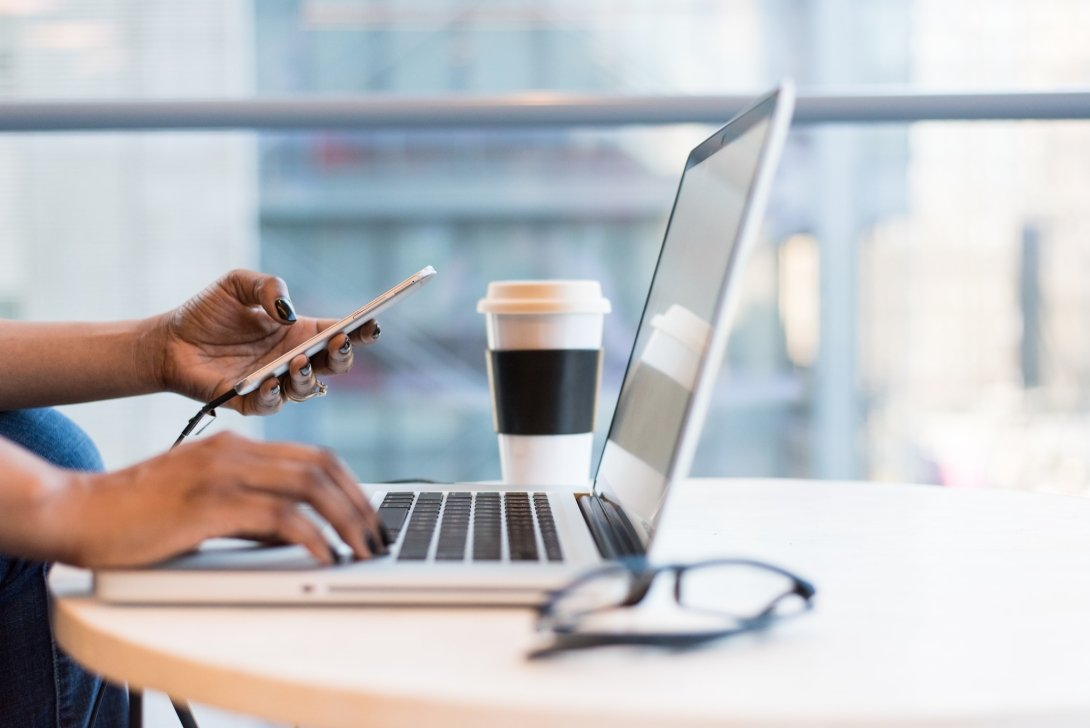 Person working at laptop (only hands and laptop visible)
