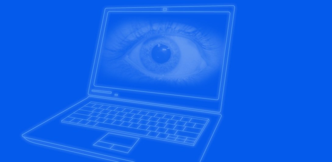 An open laptop with a giant eyeball on its screen.