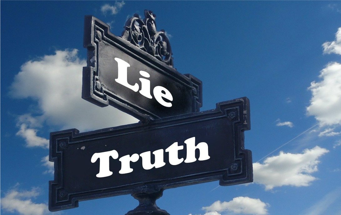 Street sign reading "lie" intersecting with one reading "truth"