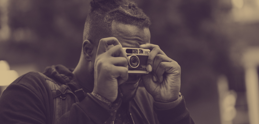 Man holding a camera up to his eyes