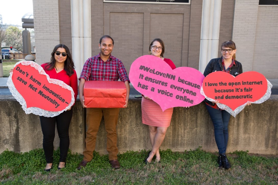 Four Free Press Action staffers holding valentines to Net Neutrality