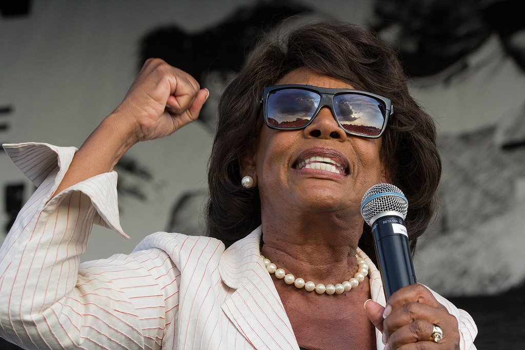 Rep. Maxine Waters speaking into a microphone