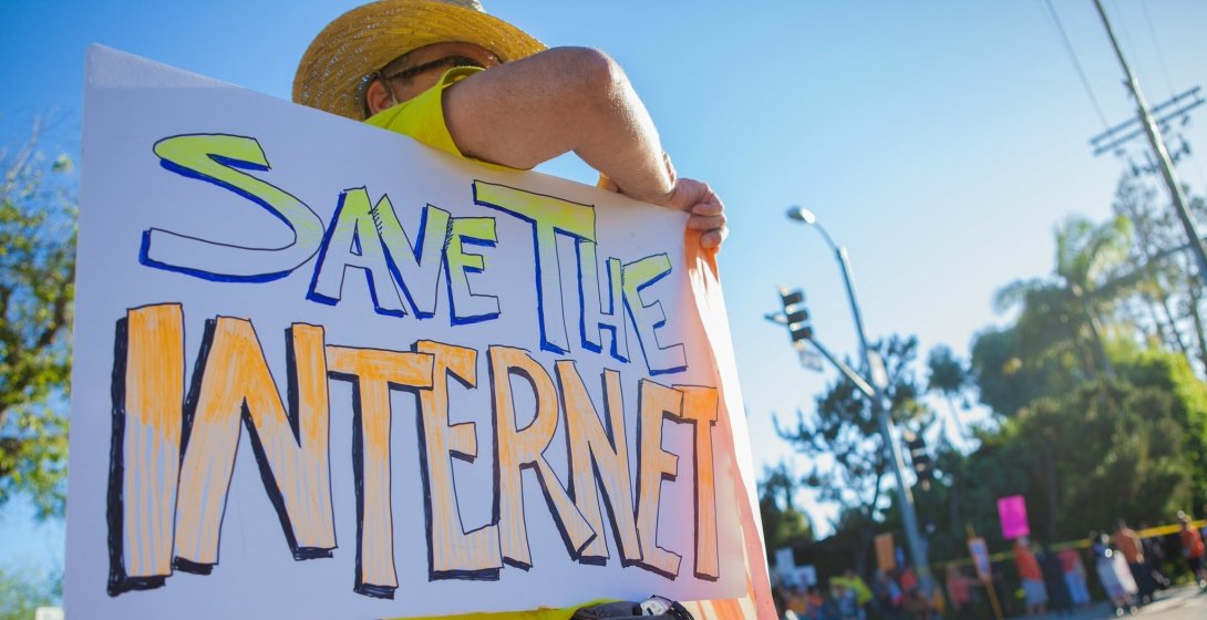 Person with poster reading "Save the internet"
