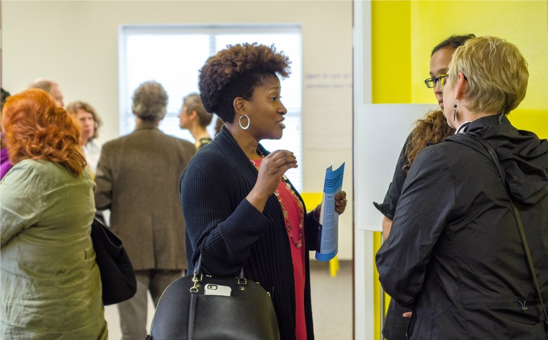 Woman in profile talking to two other people