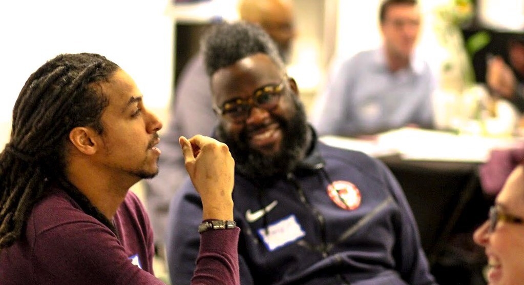 Two participants talking at a News Voices: North Carolina event.
