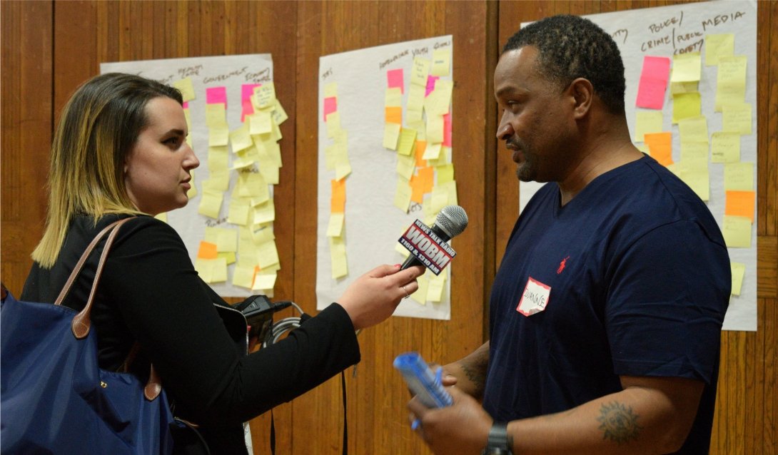 A reporter interviewing a man at a News Voices event.