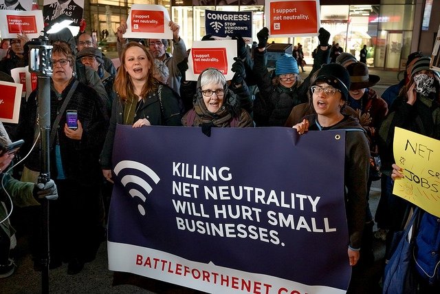 NYC protesters holding a Battle for the Net banner