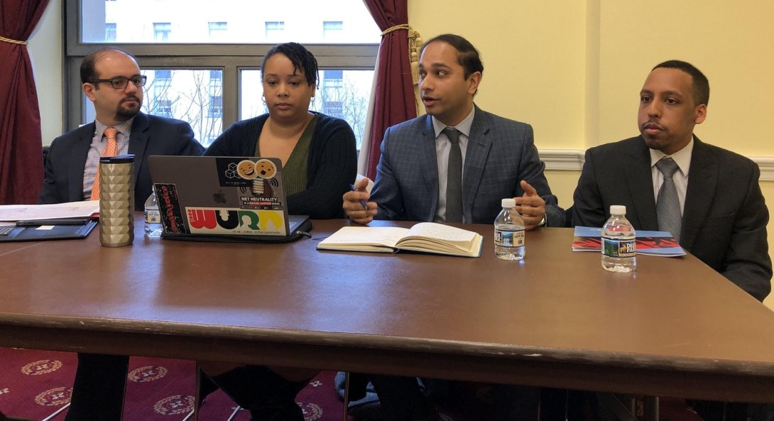 Four panelists participating in this anti-merger discussion