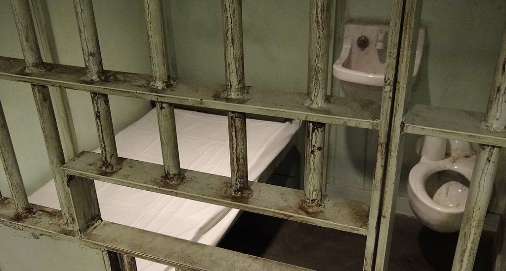 Prison cell with a bed, sink and toilet