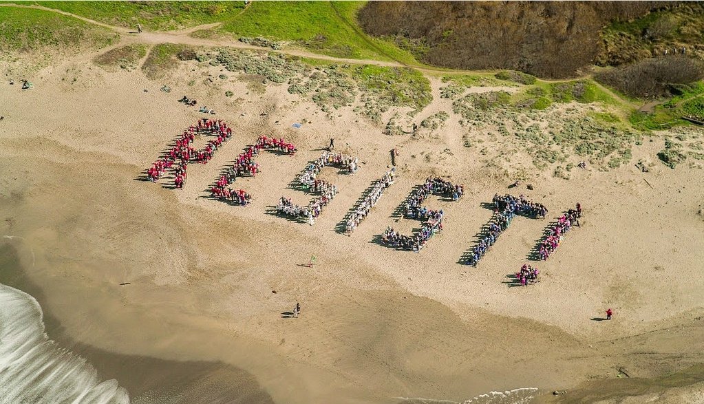 The word "resist" spelled out on a beach