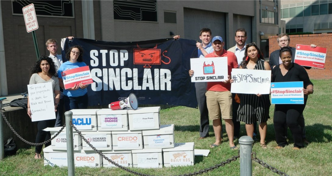 Activists with boxes of petitions and "Stop Sinclair" sign