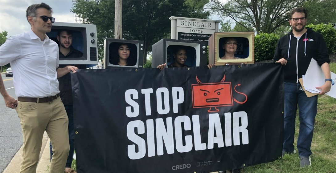 Activists holding "Stop Sinclair" banner