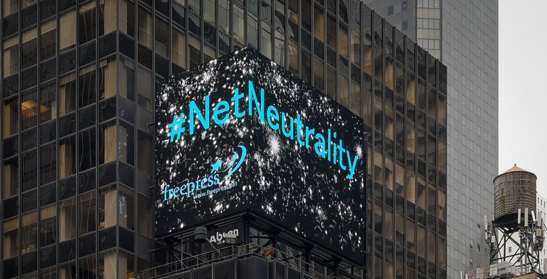 Times Square electronic billboard displaying the words "Net Neutrality" + the Free Press logo