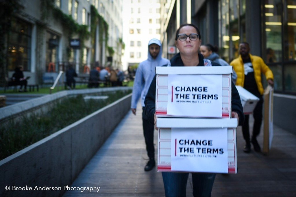 Free Press' Jessica J. Gonzalez holding boxes of petitions