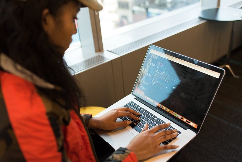 person types on computer