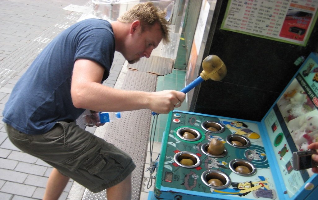 Man playing Whack-a-Mole