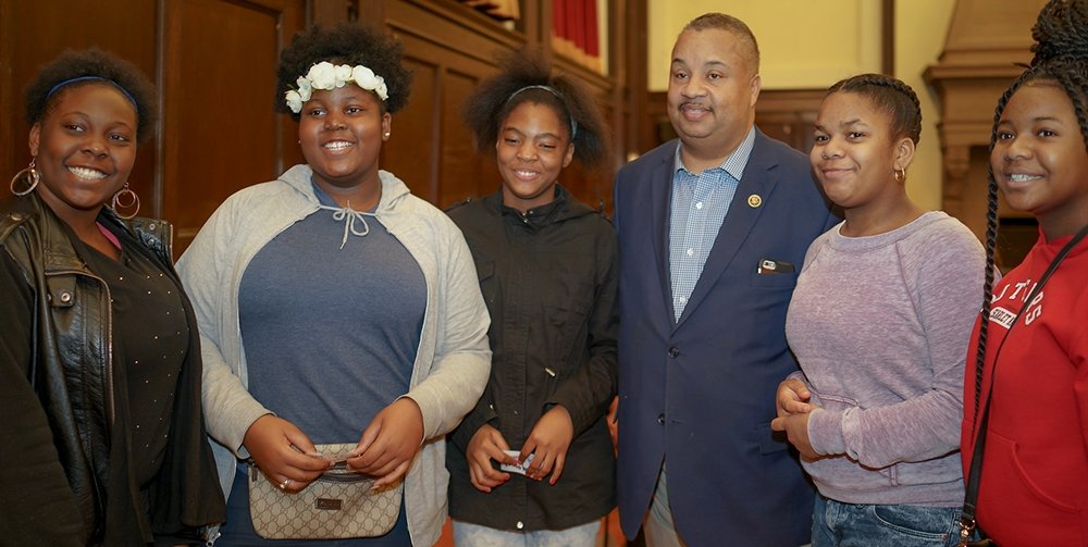Five young women with Rep. Donald Payne Jr.