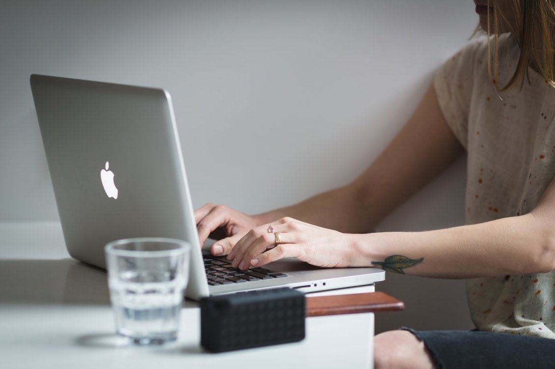 Woman typing on a Macbook