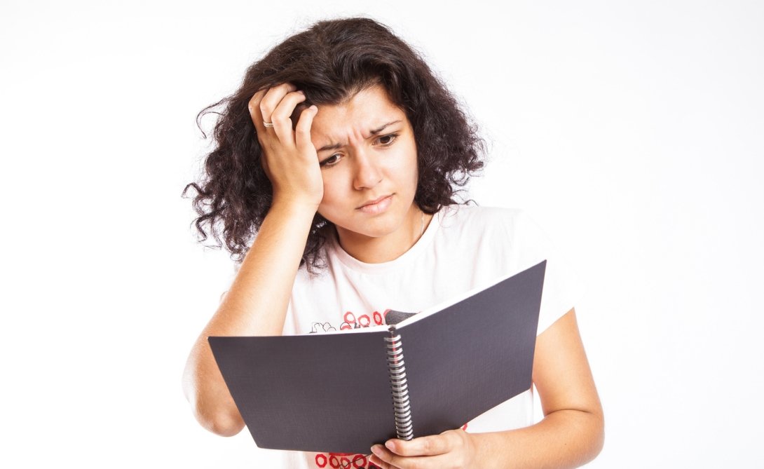 Woman reading with confused expression