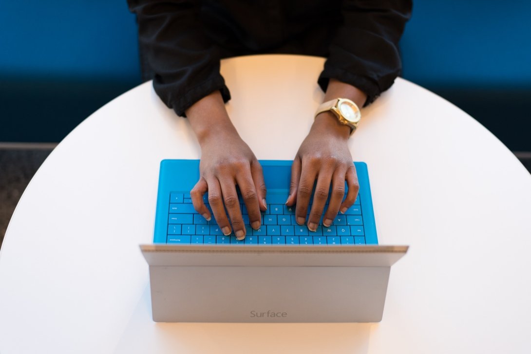 Hands typing on laptop