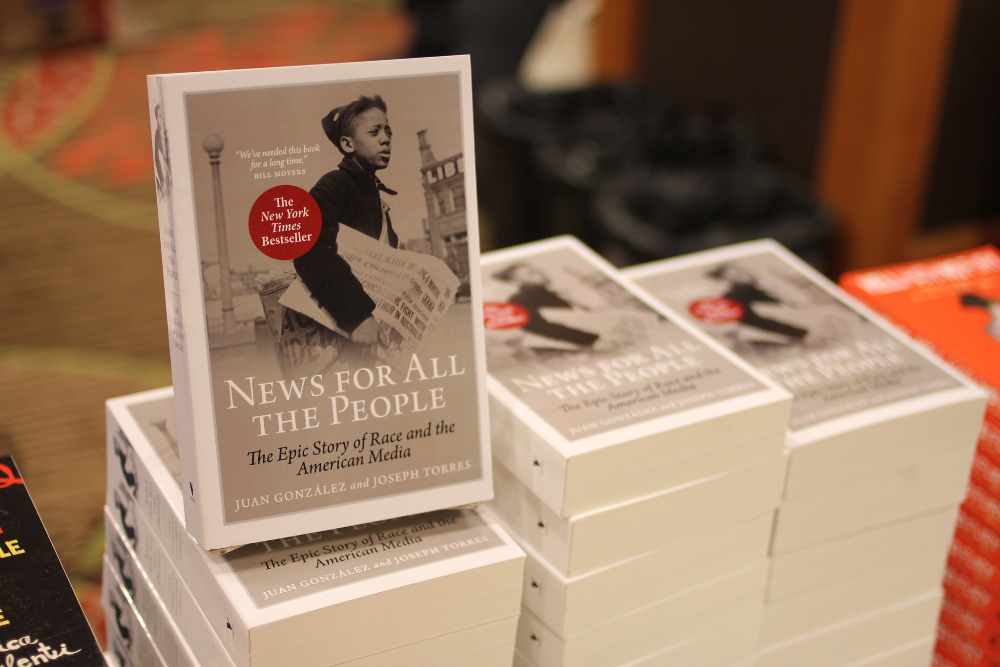 Stacks of the book "News for All the People"