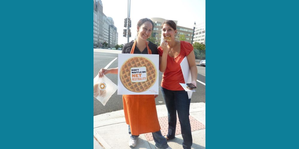 Free Press' Misty Perez Truedson and Jenn Topper holding waffles and the sign "Don't